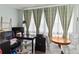 Bright office space with a large desk and a window with patterned curtains at 4189 Heron Way # 406E, Bradenton, FL 34205