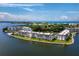 Highlighted condo in an aerial view of waterfront buildings surrounded by water and greenery at 4310 Falmouth Dr # 105, Longboat Key, FL 34228