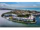 Aerial view of waterfront condos with tennis courts, community pool, and private boat docks at 4310 Falmouth Dr # 105, Longboat Key, FL 34228