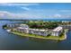 Aerial view of waterfront condos with boat docks surrounded by beautiful water and lush landscaping at 4310 Falmouth Dr # 105, Longboat Key, FL 34228