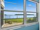 View from the bedroom of the bay, and lush green grass at 4310 Falmouth Dr # 105, Longboat Key, FL 34228