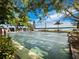 Outdoor bocce court with nearby water views, surrounded by lush greenery and palm trees at 4310 Falmouth Dr # 105, Longboat Key, FL 34228
