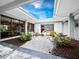 Enclosed courtyard with a fountain, white rock landscaping, and ample natural light at 4310 Falmouth Dr # 105, Longboat Key, FL 34228