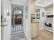 Inviting entryway with modern storm door, tiled floors, and a glimpse into the kitchen at 4310 Falmouth Dr # 105, Longboat Key, FL 34228