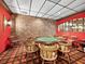 Game room with a poker table and brick accent wall, providing a cozy entertainment space at 4310 Falmouth Dr # 105, Longboat Key, FL 34228