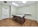 Fun game room showcasing an air hockey table on a hardwood floor with simple vertical lines at 4310 Falmouth Dr # 105, Longboat Key, FL 34228