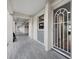 Long outdoor hallway features tiled flooring, white pillars, and a secure entrance to condos at 4310 Falmouth Dr # 105, Longboat Key, FL 34228