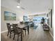 Open-concept living and dining area with water views and access to the outdoors at 4310 Falmouth Dr # 105, Longboat Key, FL 34228