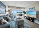 Comfortable living room showcasing a plush blue sofa, stylish decor, and stunning waterfront views at 4310 Falmouth Dr # 105, Longboat Key, FL 34228
