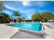 Large swimming pool surrounded by lounge chairs and palm trees, offering a refreshing retreat at 4310 Falmouth Dr # 105, Longboat Key, FL 34228