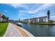 Scenic waterfront view with boats docked along beautifully landscaped condo buildings at 4310 Falmouth Dr # 105, Longboat Key, FL 34228