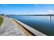 Paver sidewalk with rock bed edging runs alongside a calming body of water at 4310 Falmouth Dr # 105, Longboat Key, FL 34228