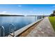 Waterfront view with a paver sidewalk and a ladder entry into the water at 4310 Falmouth Dr # 105, Longboat Key, FL 34228