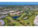 An aerial view shows the condo buildings in a scenic area with a community pool at 4550 Pinebrook Cir # 608, Bradenton, FL 34209