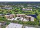 Scenic aerial view of a community with lush golf courses, serene lakes, and multiple condominium buildings at 4550 Pinebrook Cir # 608, Bradenton, FL 34209