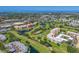 Community aerial highlighting lush golf courses, scenic ponds, and multiple condo buildings for an active lifestyle at 4550 Pinebrook Cir # 608, Bradenton, FL 34209