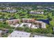 An aerial view shows the condo complex surrounded by ponds and a golf course at 4550 Pinebrook Cir # 608, Bradenton, FL 34209