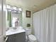 Inviting bathroom with a gray vanity, modern fixtures, and a decorative mirror with a framed print at 4550 Pinebrook Cir # 608, Bradenton, FL 34209