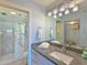 Well-lit bathroom featuring a granite countertop, white vanity, and a glass-enclosed shower at 4550 Pinebrook Cir # 608, Bradenton, FL 34209