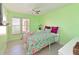 Charming bedroom with vibrant green walls, a ceiling fan, and a cozy floral-patterned bedspread at 4550 Pinebrook Cir # 608, Bradenton, FL 34209