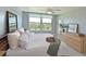Bright bedroom featuring a large window with scenic views, neutral decor, and a ceiling fan at 4550 Pinebrook Cir # 608, Bradenton, FL 34209