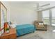 Cozy bedroom with a comfortable armchair, natural light, and neutral tones, perfect for relaxation at 4550 Pinebrook Cir # 608, Bradenton, FL 34209