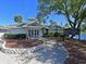 Community clubhouse with manicured landscaping, convenient parking, and serene lake views at 4550 Pinebrook Cir # 608, Bradenton, FL 34209