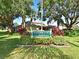 Beautiful Pinebrook clubhouse sign amidst lush landscaping and mature trees at 4550 Pinebrook Cir # 608, Bradenton, FL 34209