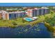 Condos overlook a community pool with a lake in the background at 4550 Pinebrook Cir # 608, Bradenton, FL 34209