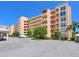 An exterior view showing the condo building and parking on a sunny day at 4550 Pinebrook Cir # 608, Bradenton, FL 34209