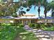 Inviting condominium clubhouse with a brick path and well-manicured landscaping at 4550 Pinebrook Cir # 608, Bradenton, FL 34209