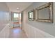 Hallway with tile floors and custom details that leads to a balcony with outdoor seating at 4550 Pinebrook Cir # 608, Bradenton, FL 34209