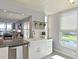 Modern kitchen island with a stainless steel dishwasher and farmhouse style sink at 4550 Pinebrook Cir # 608, Bradenton, FL 34209
