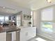 Modern kitchen island with a stainless steel dishwasher and farmhouse style sink at 4550 Pinebrook Cir # 608, Bradenton, FL 34209