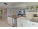 Open concept kitchen with granite counters and stainless steel dishwasher overlooking living area at 4550 Pinebrook Cir # 608, Bradenton, FL 34209