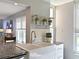 Modern kitchen island with a stainless steel dishwasher and farmhouse style sink at 4550 Pinebrook Cir # 608, Bradenton, FL 34209