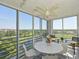 Relaxing lanai with scenic golf course views, floor-to-ceiling windows, and comfortable seating at 4550 Pinebrook Cir # 608, Bradenton, FL 34209