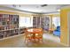 Bright library with floor-to-ceiling bookshelves and a round wooden table at 4550 Pinebrook Cir # 608, Bradenton, FL 34209