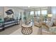 A living room with stylish furniture, decor, and views of the neighborhood at 4550 Pinebrook Cir # 608, Bradenton, FL 34209
