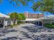 View of covered parking spaces in a well-maintained area surrounded by lush trees and landscaping at 4550 Pinebrook Cir # 608, Bradenton, FL 34209
