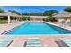 A large community swimming pool with lounge chairs and pristine, clear water at 4550 Pinebrook Cir # 608, Bradenton, FL 34209