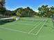 Well-maintained tennis court surrounded by lush greenery in a vibrant community at 4550 Pinebrook Cir # 608, Bradenton, FL 34209