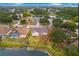 Aerial view of a neighborhood with houses, pond, and mature trees at 4621 34Th E Ct, Bradenton, FL 34203