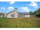 Wide view of the backyard, including grass and the back of the house at 4621 34Th E Ct, Bradenton, FL 34203