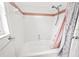 Clean, tiled bathroom featuring a bathtub/shower combo with white and pink tile accents at 4621 34Th E Ct, Bradenton, FL 34203