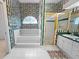 Charming bathroom featuring patterned wallpaper, a bathtub, and a vanity with green counter at 4621 34Th E Ct, Bradenton, FL 34203