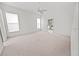 Spacious bedroom with neutral tones, ceiling fan, and doorway to a bathroom or closet at 4621 34Th E Ct, Bradenton, FL 34203