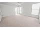 Large, well-lit bedroom features plush carpet, ceiling fan, and windows with blinds at 4621 34Th E Ct, Bradenton, FL 34203