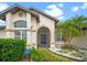 Close-up of a home's entrance with a screened entry and lush landscaping at 4621 34Th E Ct, Bradenton, FL 34203