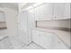 Efficient kitchen with ample white cabinetry, modern appliances, and tiled flooring at 4621 34Th E Ct, Bradenton, FL 34203